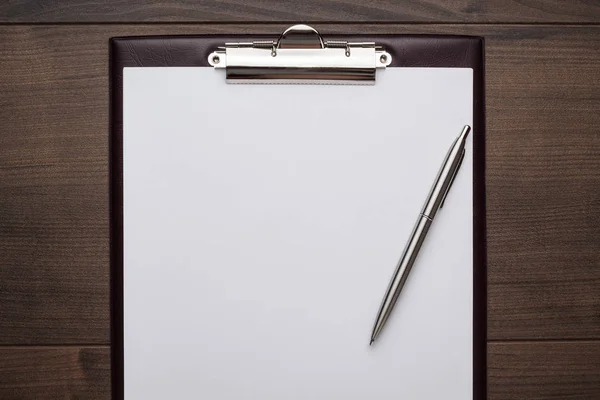 Brown wooden office table with notepad — Stock Photo, Image