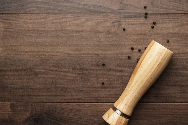 Wooden pepper mill on the table — Stock Photo, Image