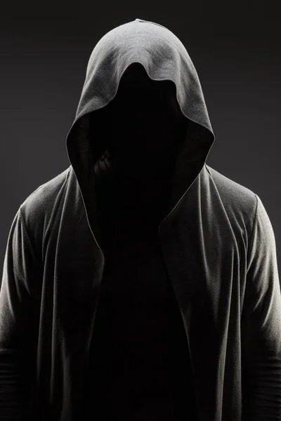man in the hood over grey background