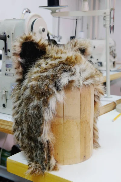 Sewing shop with fur cap — Stock Photo, Image
