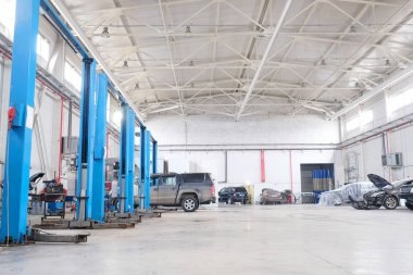 Cars in a car repair station in Stupino clipart