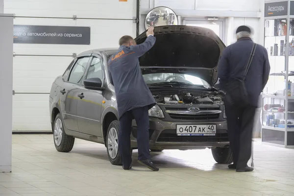 Elderly owner of the car and the master-receiver inspect the car — Stock Photo, Image