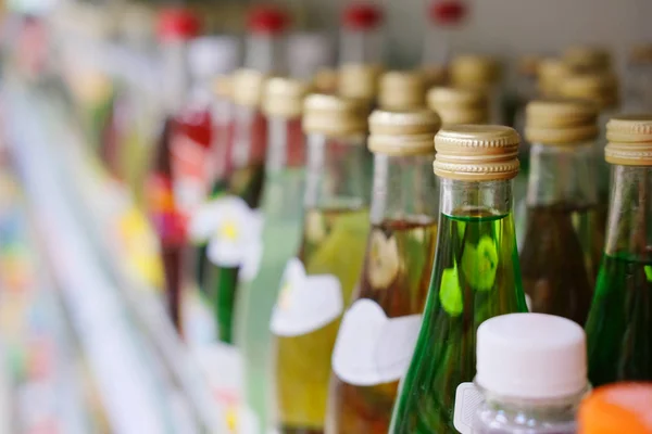 Bottles on a shelf in a supermarket — Stock Photo, Image