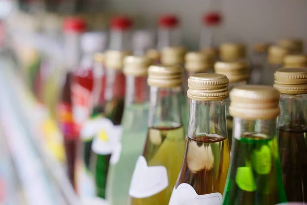 Bottles on a shelf in a supermarket — Stock Photo, Image