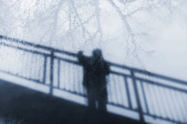 Reflection of man's silhouette on the river surface — Stock Photo, Image