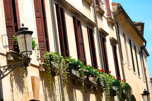 Цветочный горшок на окнах жилого дома в Падуе
