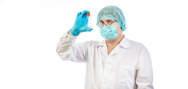 Lab technician looks at a test tube of clear liquid — Stock Photo, Image