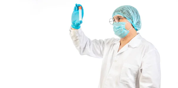 Lab technician looks at a test tube of clear liquid — Stock Photo, Image