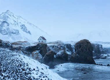 Cliffs near Arnarstapi village at dusk in winter. clipart