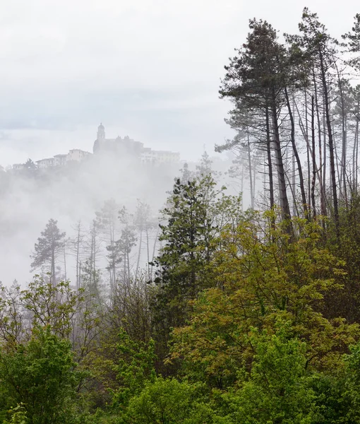 Old small town on a hill in a foggy morning — Stock Photo, Image