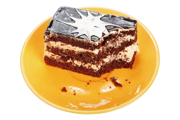 Bolo de chocolate mordido no prato laranja — Fotografia de Stock