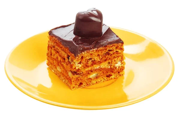 Chocolate cake on orange plate — Stock Photo, Image
