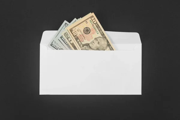 White paper envelope with money on black background — Stock Photo, Image