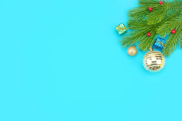 Christmas border with branches of spruce, christmas toys on a blue background — Stock Photo, Image