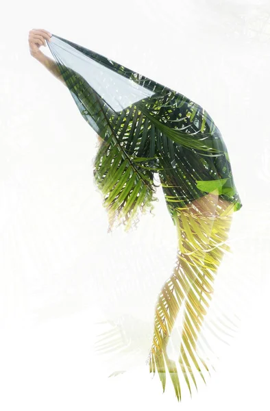 Woman silhouette combined with palm leaves — Stock Photo, Image