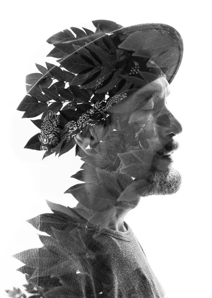 Man wearing hat combined with tree leaves — Stock Photo, Image