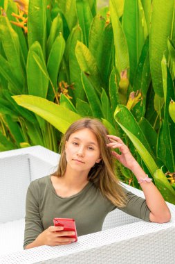 Genç kız akıllı telefonunu kullanıyor.