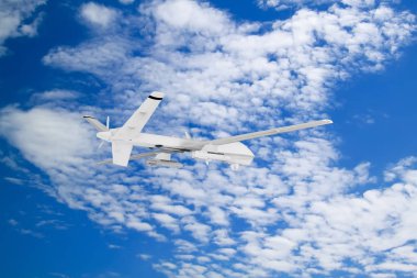 military RC military drone flies against the backdrop of blue peaceful sky with white clouds