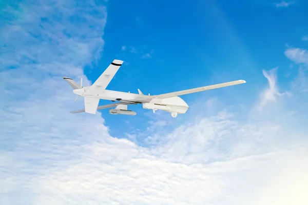 military RC military drone flies against the backdrop of blue peaceful sky with white clouds