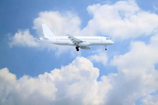 Biały Samolot Pasażerski Wchodzi Ląd Naturalnym Tłem Białych Chmur Błękitnego — Zdjęcie stockowe