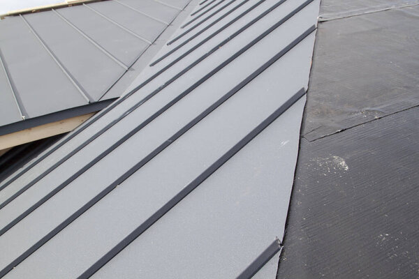 close up view of grey folding roof under construction on waterproofing layer