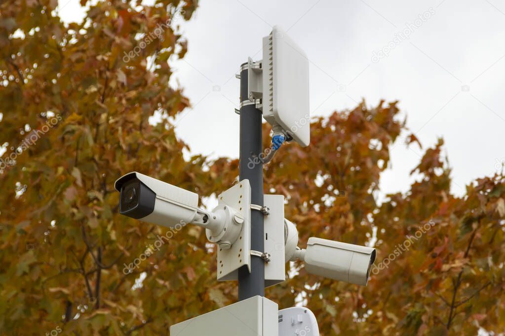 outdoor surveillance cameras and wireless access points in autumn city park