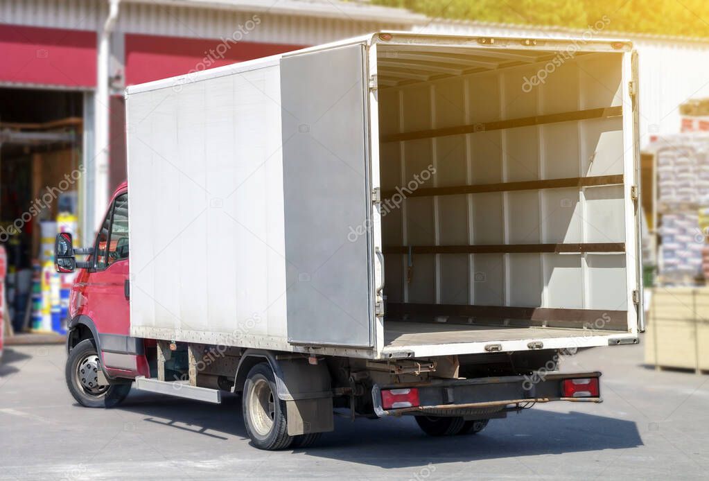 small truck with red cab stands with open empty body ready for loading cargo. ?lipping path is included