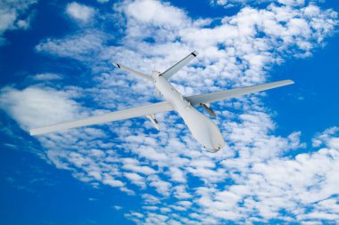 Askeri RC askeri İHA 'sı mavi gökyüzü arka planındaki güzel bulutların zemininde uçuyor.