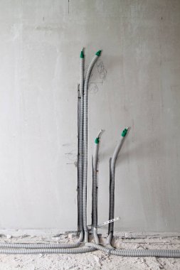 Elektrik kablosu, duvardaki oyukta koruma kablosuna yerleştirilir. Elektrik kabloları prizleri ve anahtarları birbirine bağlamak için duvarda taşınır.