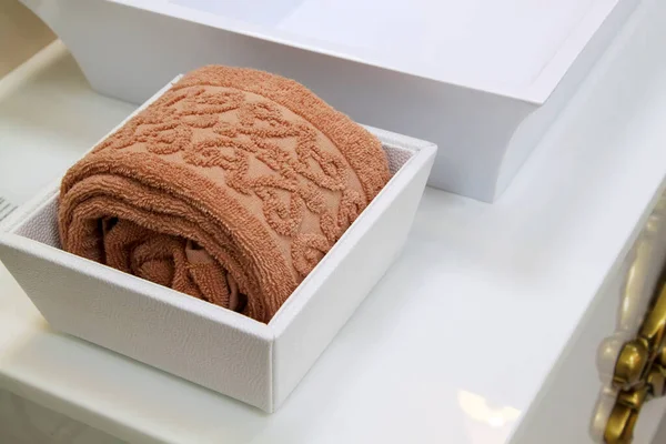 Neatly Folded Brown Towel Sits White Decorative Stand Shelf Next — Stock Photo, Image