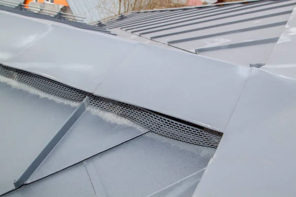 Close-up view of an independent black metal folding roof and ventilation grilles with trees and sky behind — Stock Image Close View Independent Black Metal Folding Roof Ventilation Grilles Trees Stock Picture