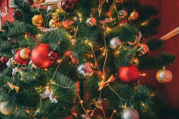 Árvore de Natal decorada com bugigangas e guirlandas — Fotografia de Stock
