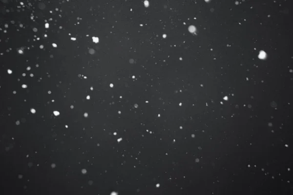 Falling snow on black background — Stock Photo, Image