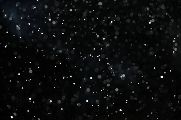 Falling snow on black background — Stock Photo, Image