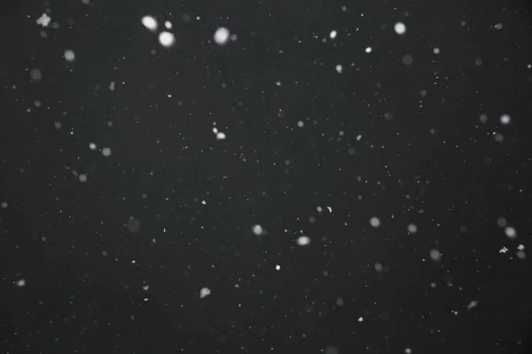 Falling snow on black background — Stock Photo, Image