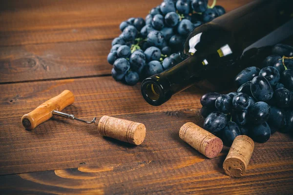 Bottle of wine, grape and corks — Stock Photo, Image