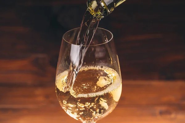 Pouring white wine from bottle — Stock Photo, Image