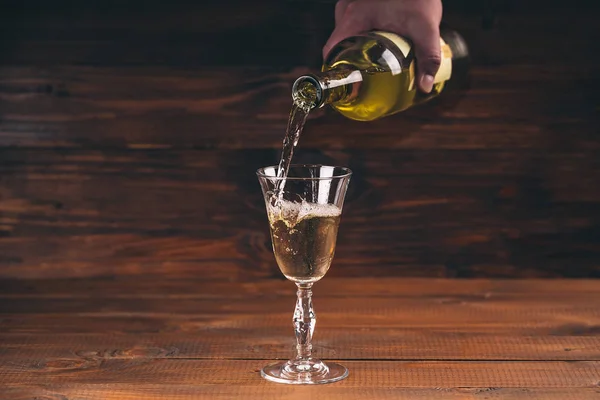 Person pouring wine from bottle — Stock Photo, Image