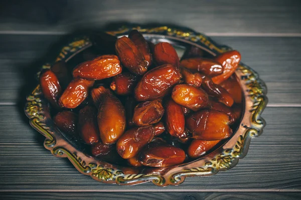 dried dates on a silver tray