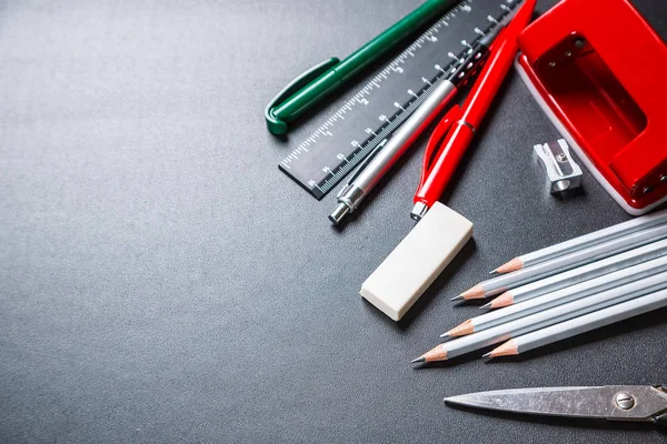 School supplies on black texture — Stock Photo, Image