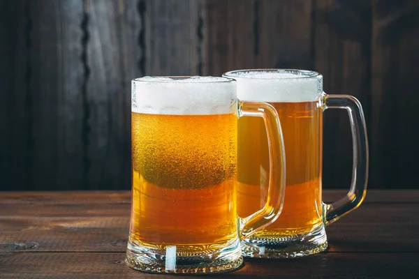 Two Mug of beer on the wooden background — Stock Photo, Image