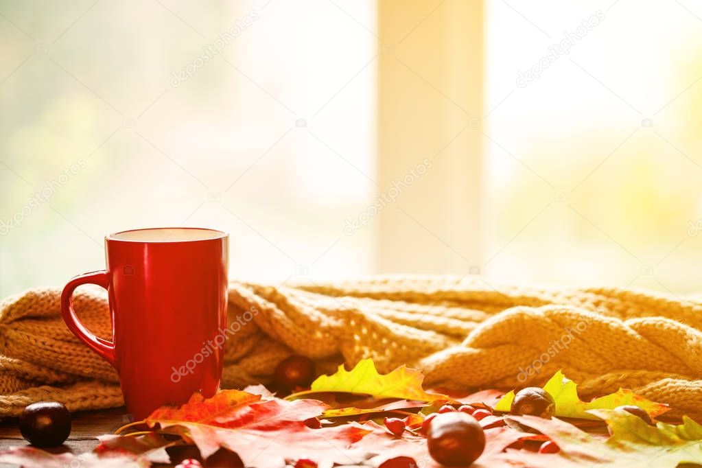 Cup of tea with yellow leaves 