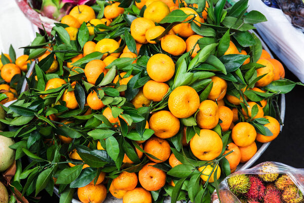 ripe tangerines at market on street