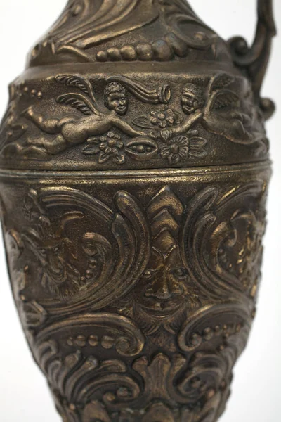 Bronze jug with a Satyr and angels, floral ornaments, arm Swan — Stock Photo, Image