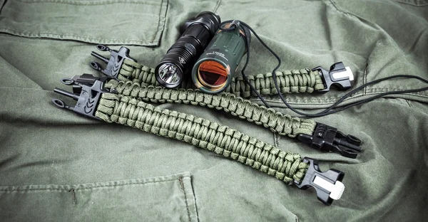 Military paracord bracelet, tactical torch and spy-glass — Stock Photo, Image
