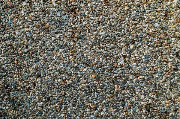 Superfície de cimento de enchimento de cascalho de granito esmagado como textura de fundo — Fotografia de Stock