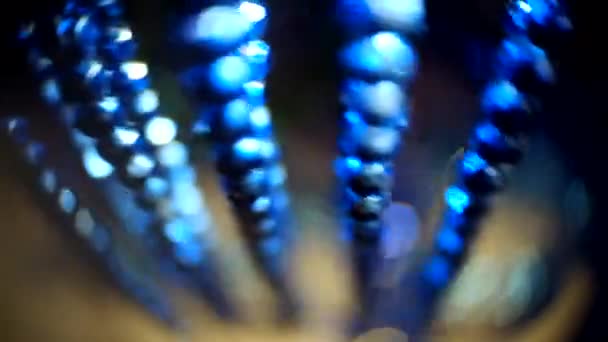 Holiday decorations garland of blue beads moving with background defocused — Stock Video