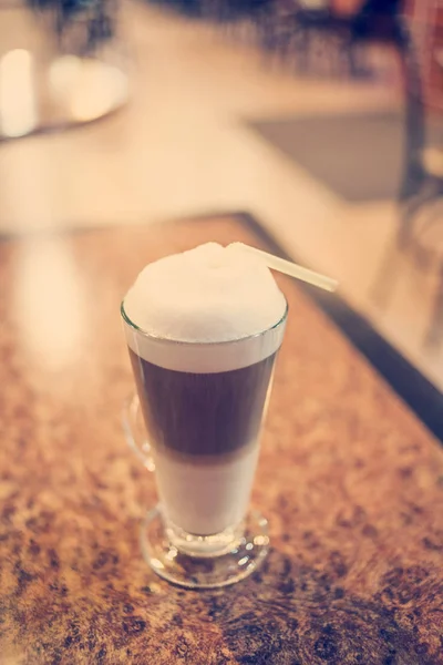 Latte coffee in glass on rare wood table, selective focus, colorized vintage shot,shallow DOF — Stock Photo, Image