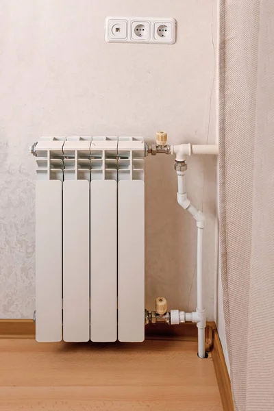 Modern hot water radiator on the wall