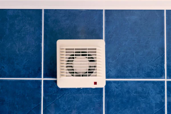 Air conditioner fan on blue tiled wall indoors — Stock Photo, Image